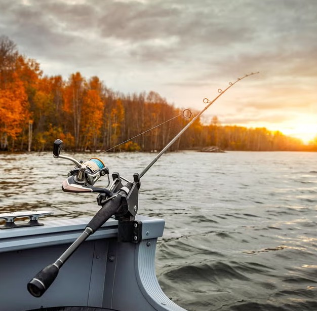 A rod resting in a boat holder at the end of an autumn day, the point at which off season service starts